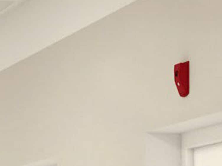 red fire alarm on ceiling