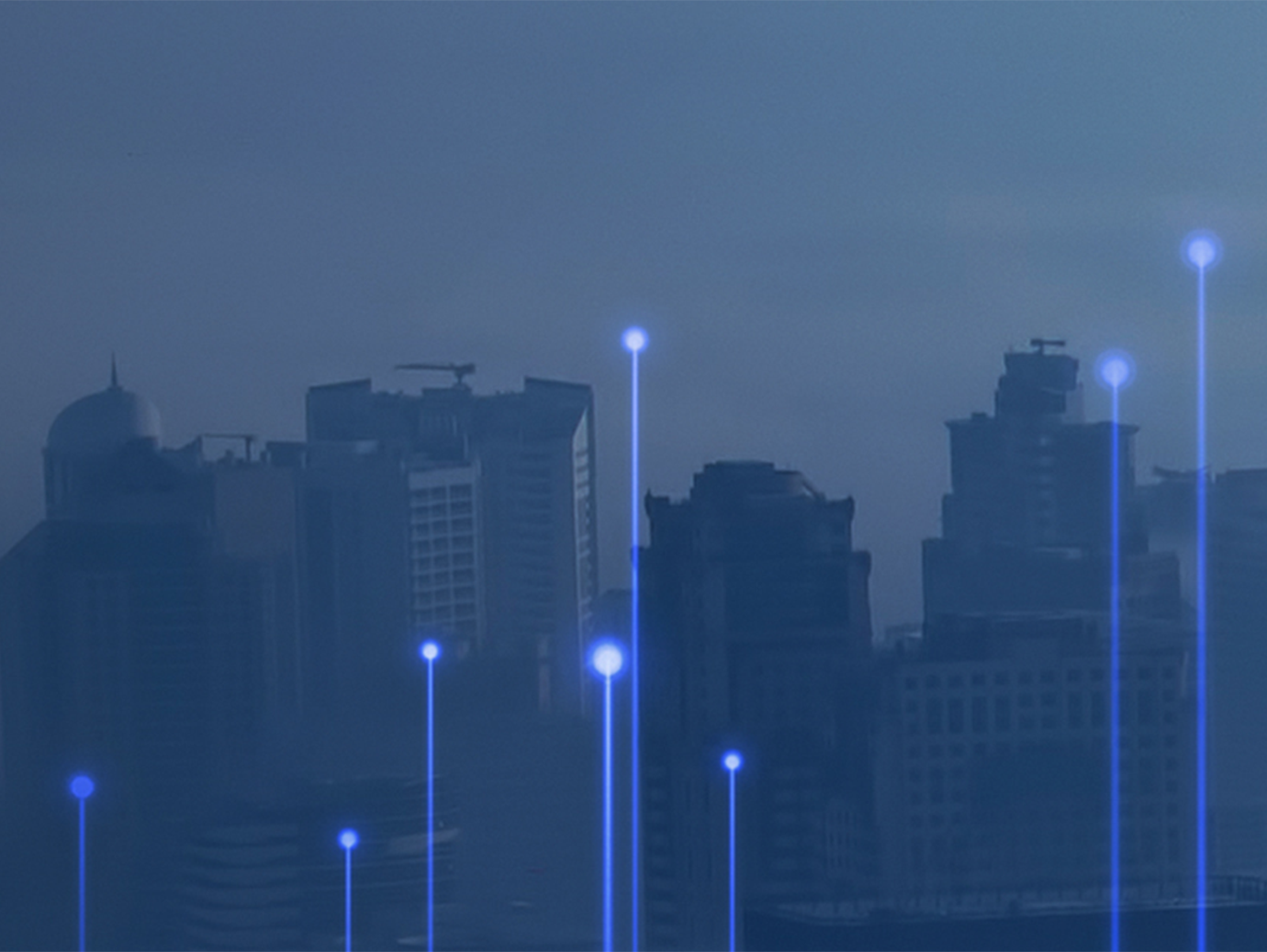 Buildings and skyscrapers cast in blue hues from fog. Data lines and dots are scattered throughout the landscape.